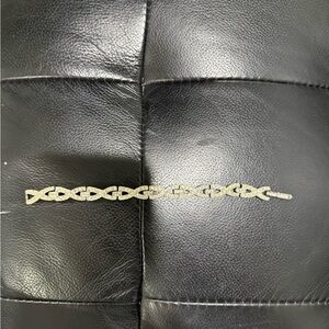 vintage  silver-tone bracelet with an interlocking 'X' or infinity w/tiny stones
